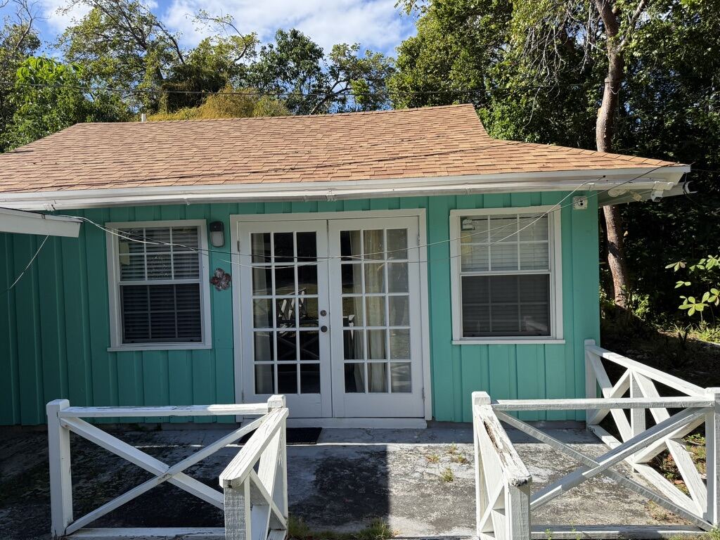 Andros Island Guest Cottage – turquoise cottage with white French doors